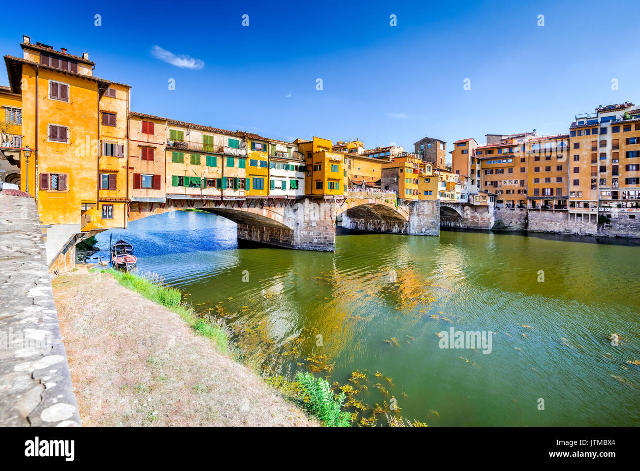 Florence, Tuscany - Ponte Vecchio, medieval bridge sunlighted over Arno River, Italy. Stock Photo