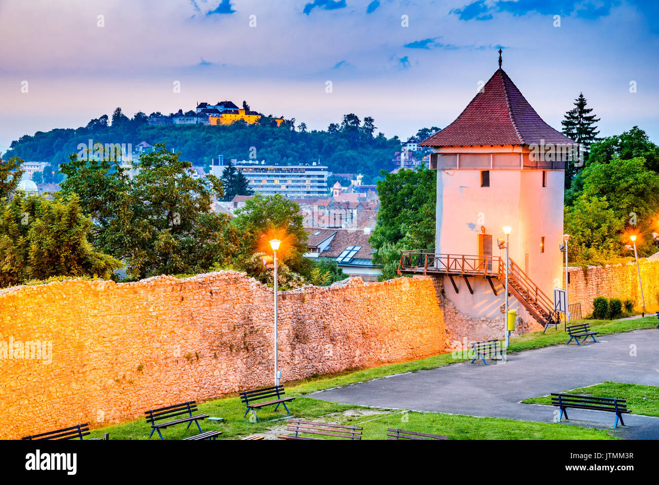 Brasov, Romania - Twilight image with medieval city walled fortifications, Black Church and the Citadel. Stock Photo