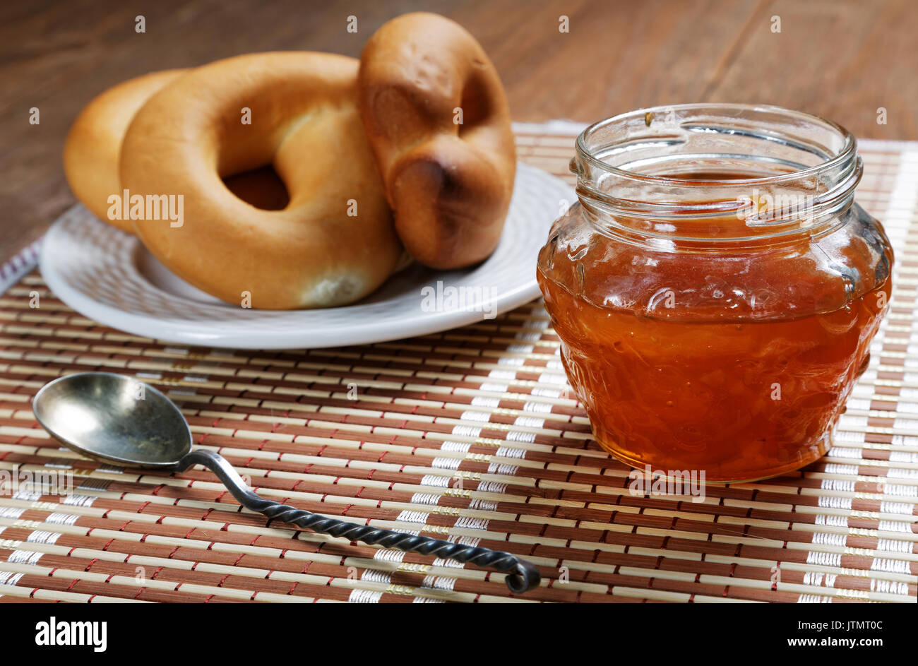 Jam jar and pretzel on the table close-up Stock Photo