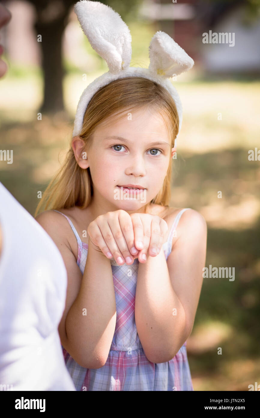 Little girl with bunny ears posing for photo. Stock Photo