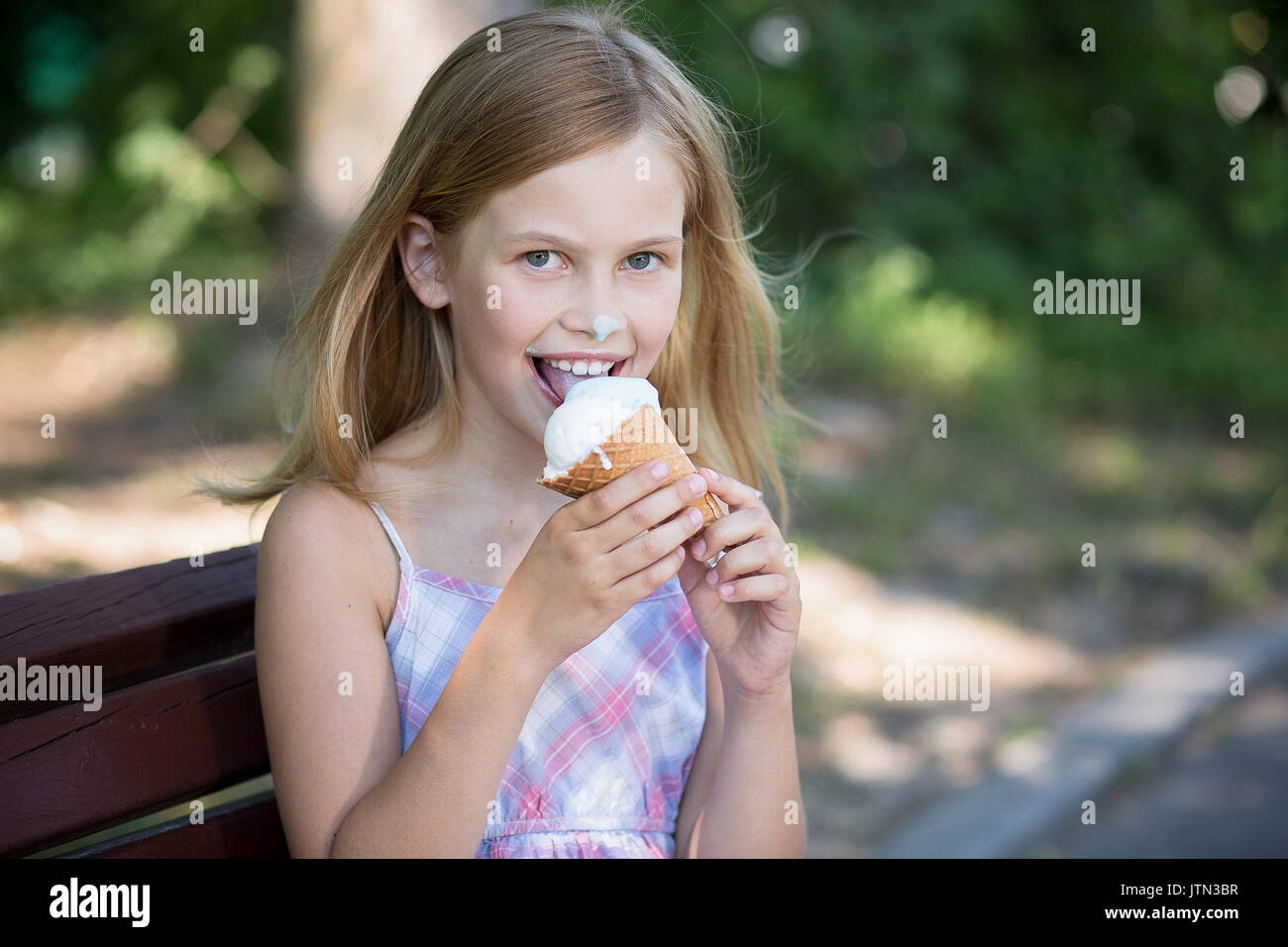 Little girl happy to eat ice cream. Stock Photo
