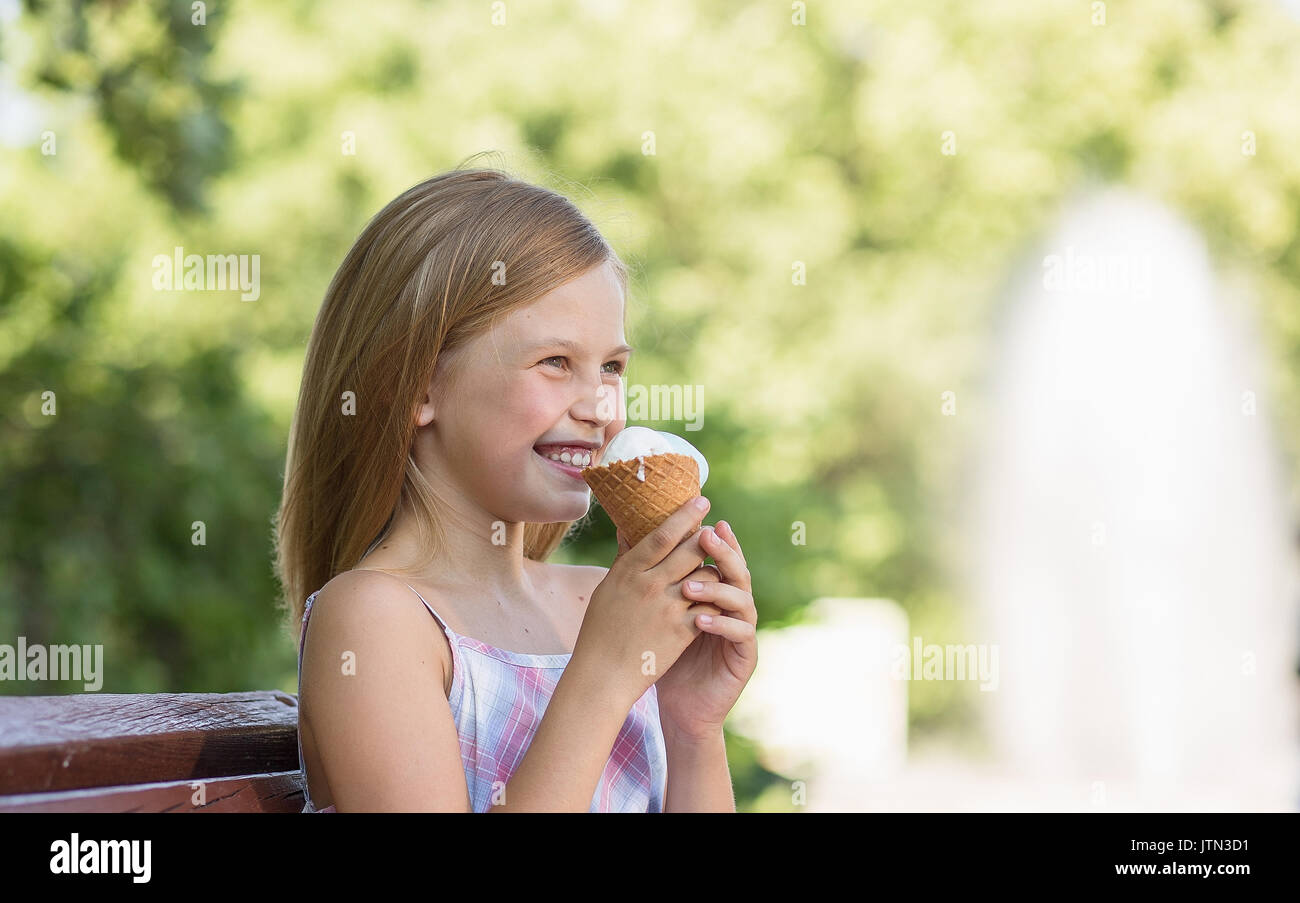 Little girl smiling holding ice cream. Stock Photo
