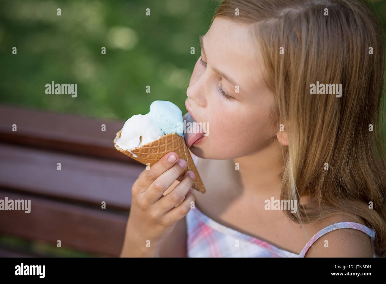 Little girl eating ice cream. Stock Photo