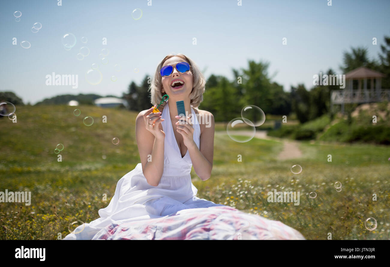 Happy woman outdoors blue hi-res stock photography and images - Alamy