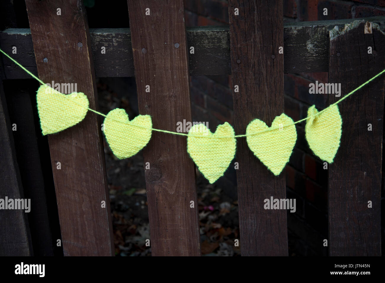 Grenfell Tower, West London. Aftermath of the tragedy. Yellow crocheted hearts to honour the missing Stock Photo