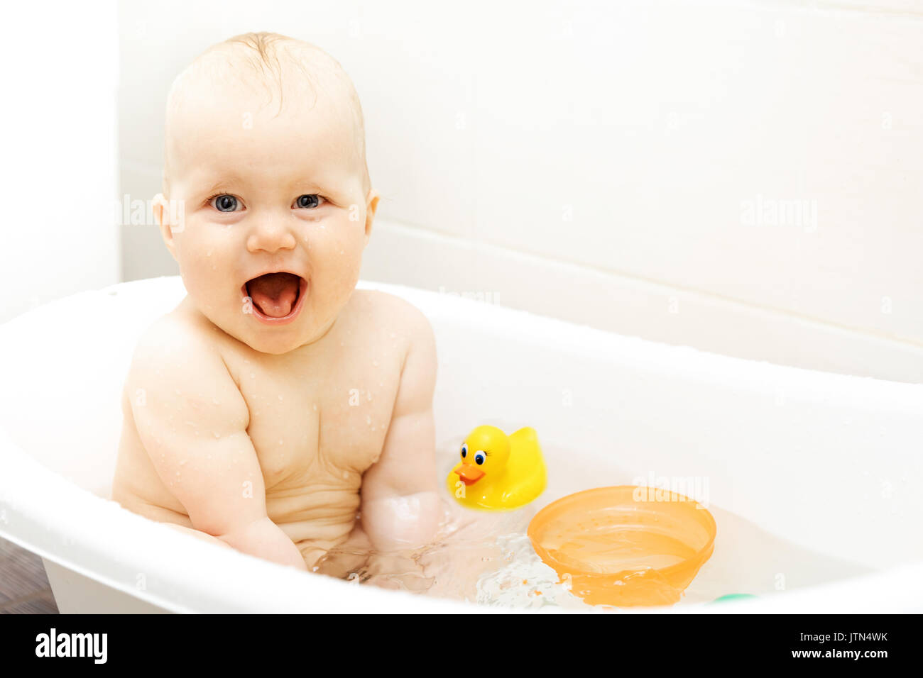 happy excited baby taking a bath Stock Photo Alamy