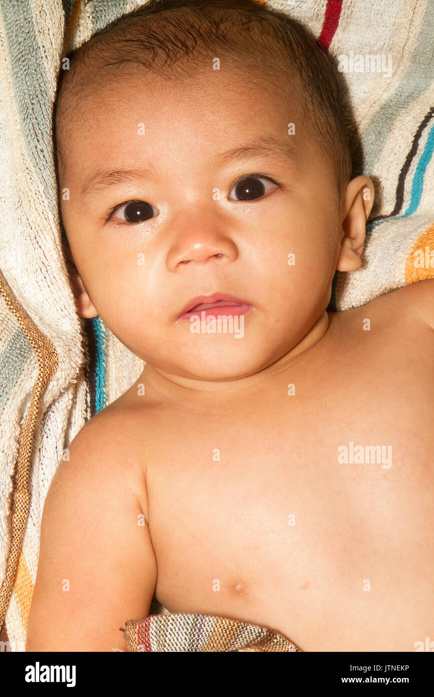 A baby boy portaiture with stripe towell background. Stock Photo