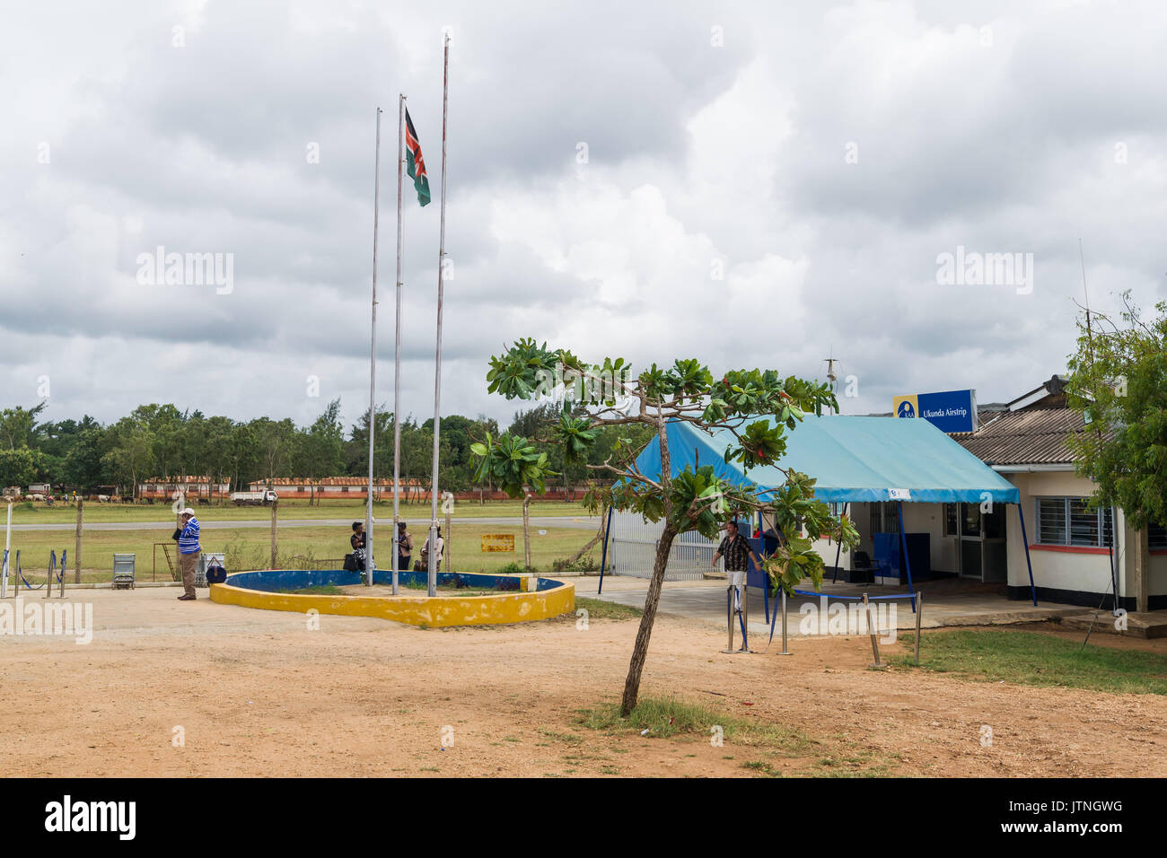 Ukunda airport airstrip terminal building with travellers outside which serves as the main airport for Diani resorts and hotels on Kenyas coast Stock Photo