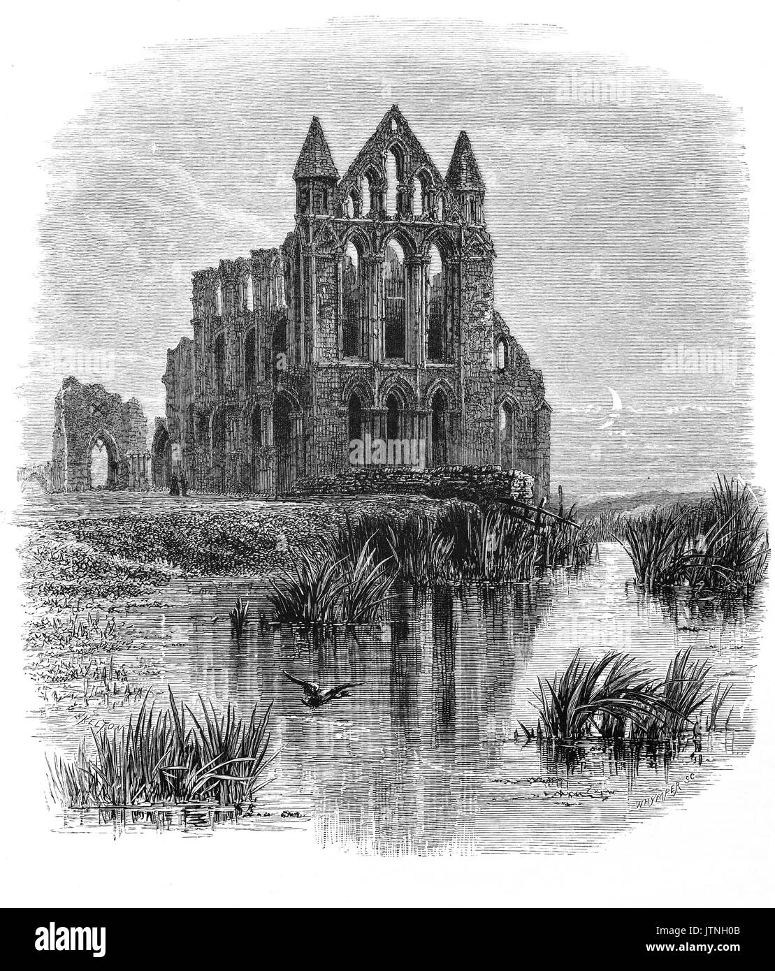 1870: Whitby Abbey in the moonlight. The 13th-century ruined Benedictine abbey overlooks the North Sea on the East Cliff above Whitby in North Yorkshire, England. It was dis-established during the Dissolution of the Monasteries- under the auspices of Henry VIII. Stock Photo