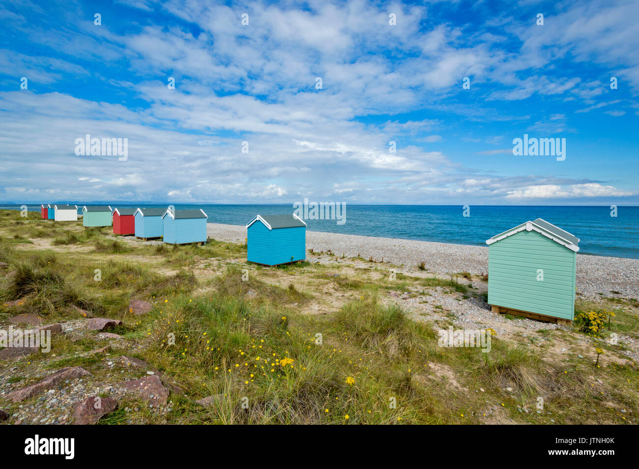 BEACH HUTS IN PASTEL COLOURS ON THE SAND AND SHINGLE BEACH FINDHORN MORAY SCOTLAND Stock Photo
