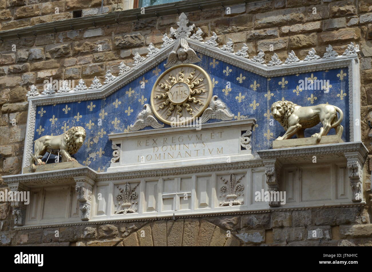 Medallion with the monogram of Christ between two lions, above to the entranc to Palazzo Vecchio in Florence. Stock Photo