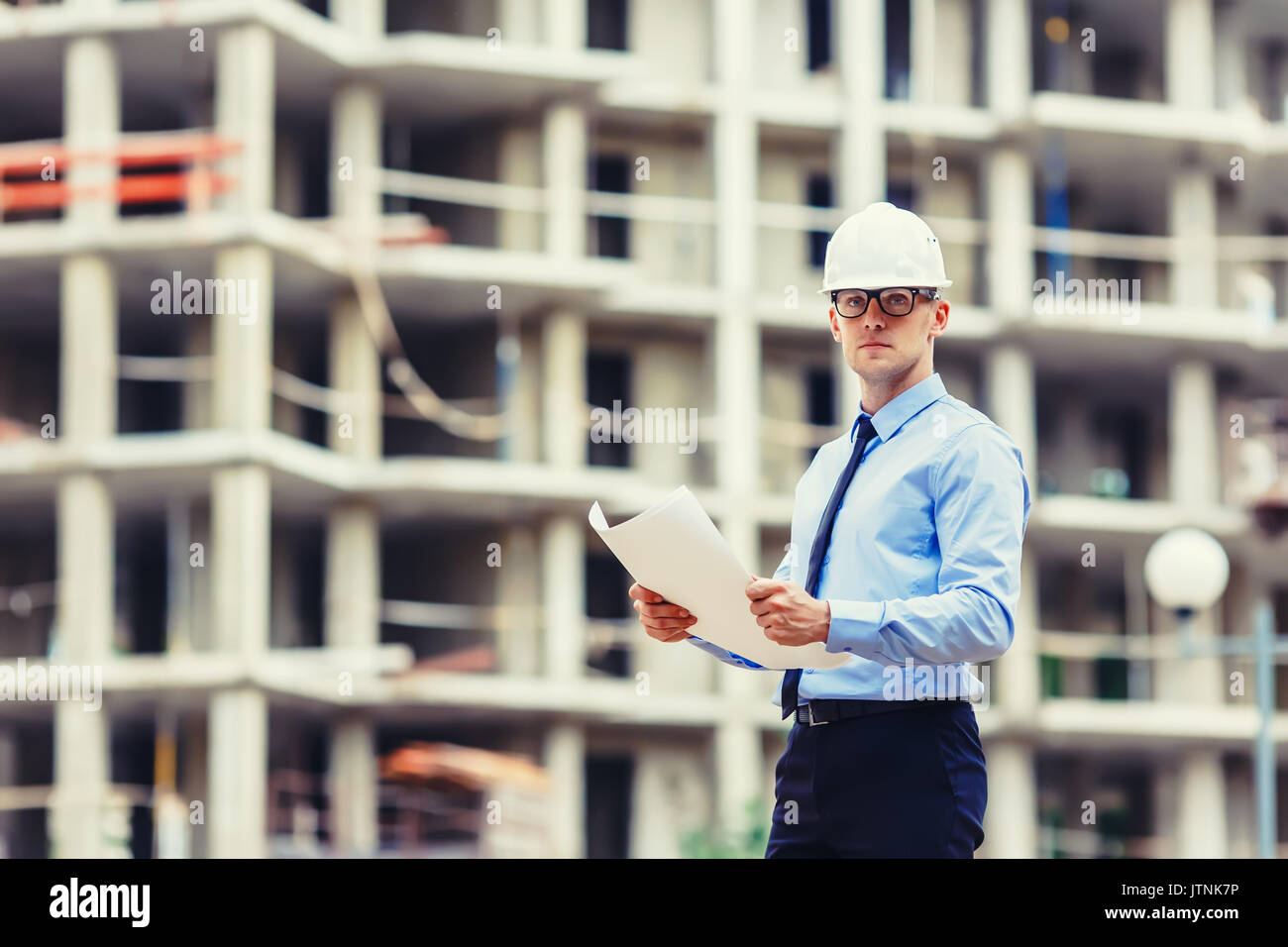 Handsom construction engineer at the construction site looking at the camera Stock Photo