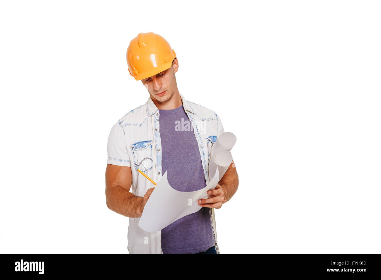 Construction engineer looking at the blueprint. Isolated on white. Stock Photo