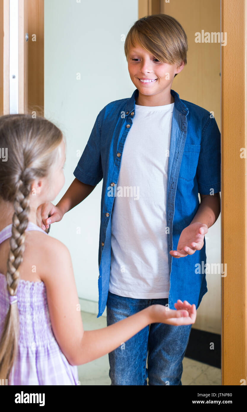 Hospitable spanish child receiving expected friend at home interior