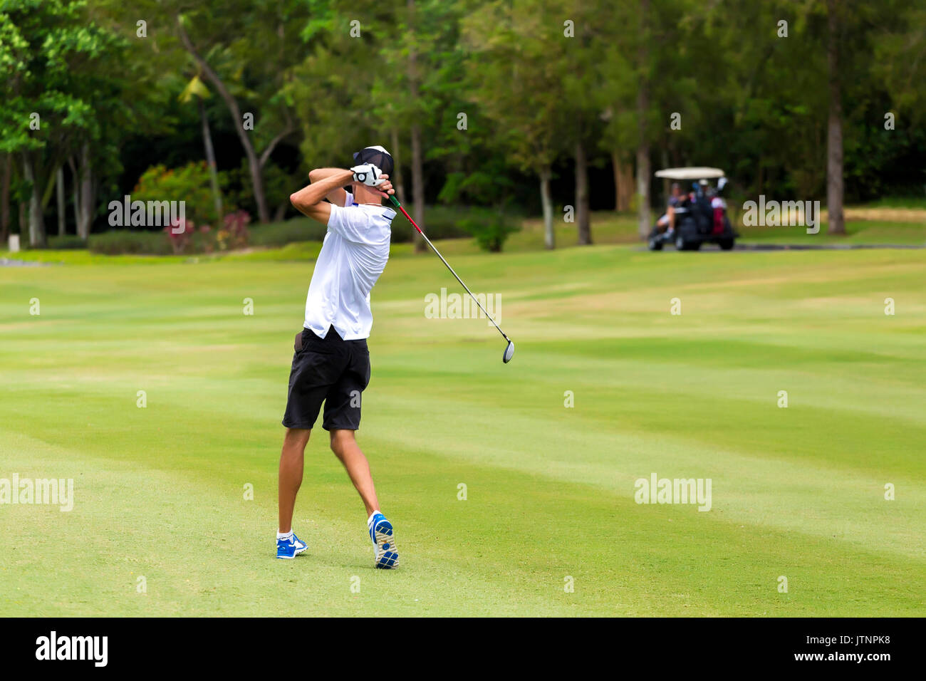 Young man playing golf, Bali, Indonesia Stock Photo