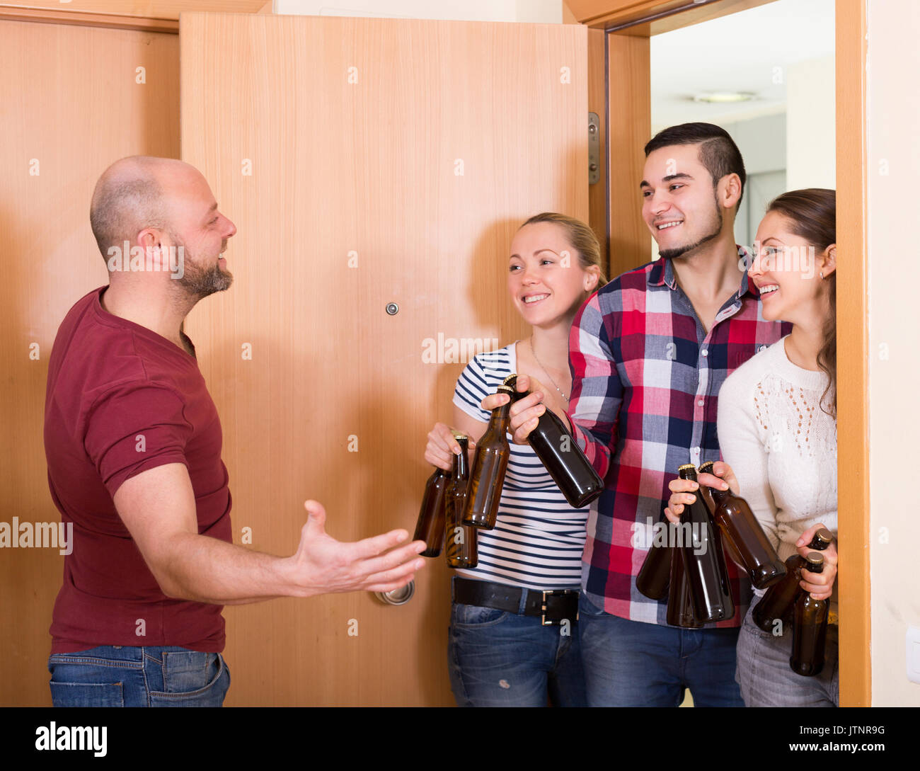 Welcoming guest into home hi-res stock photography and images - Alamy