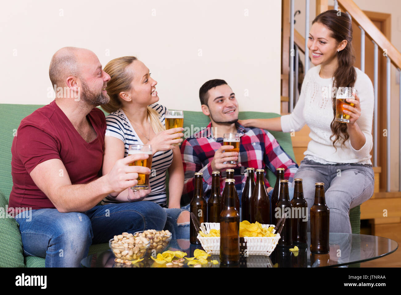 Two couples having fun at house party together at home Stock Photo Alamy