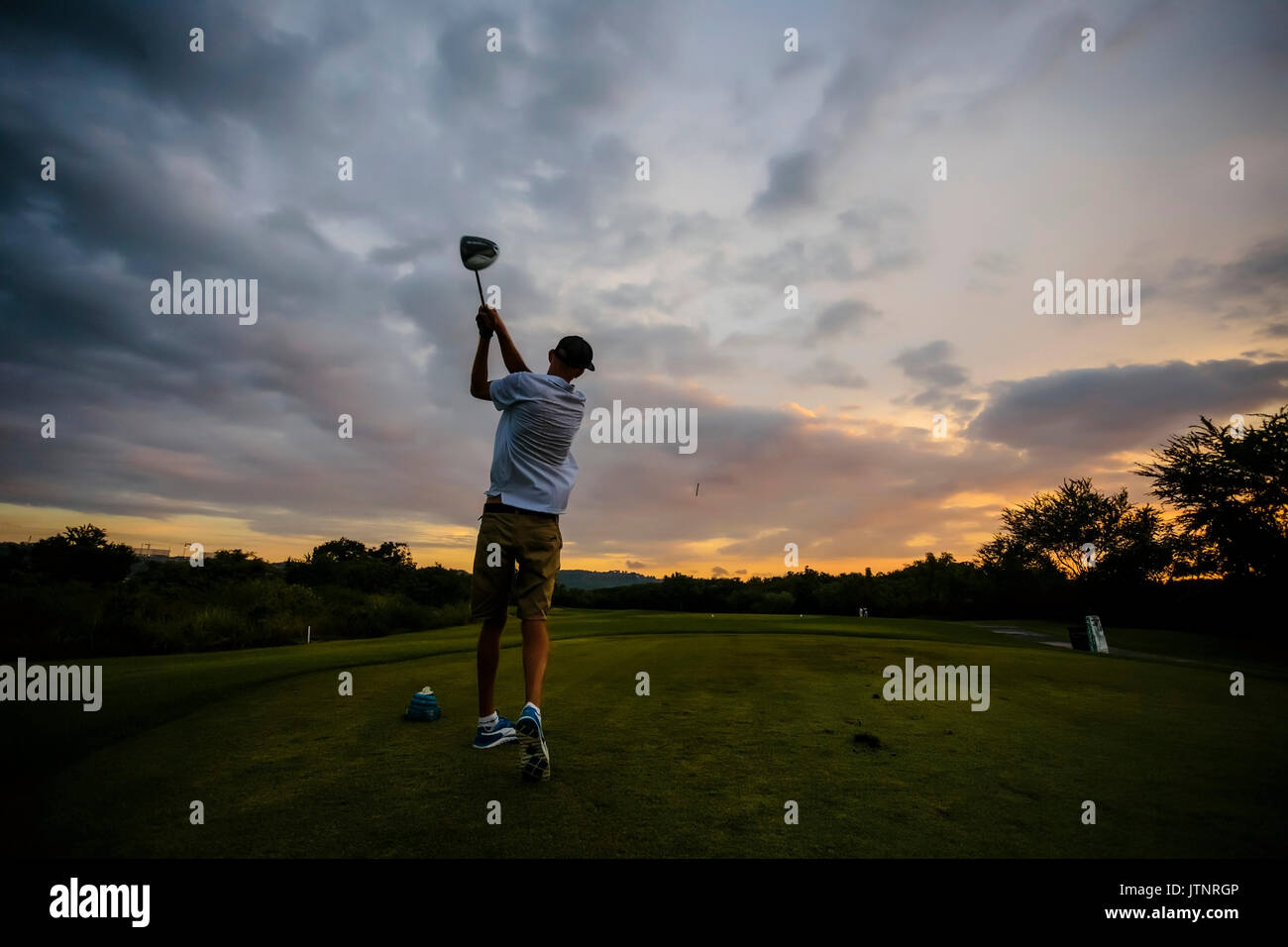 Golf player at sunset time,Bali,Indonesia Stock Photo