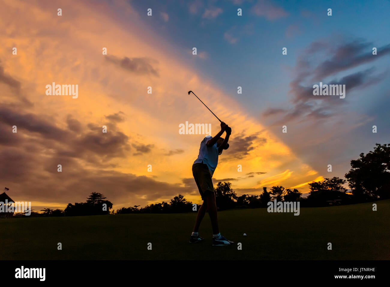 Golf player at sunset time,Bali,Indonesia Stock Photo