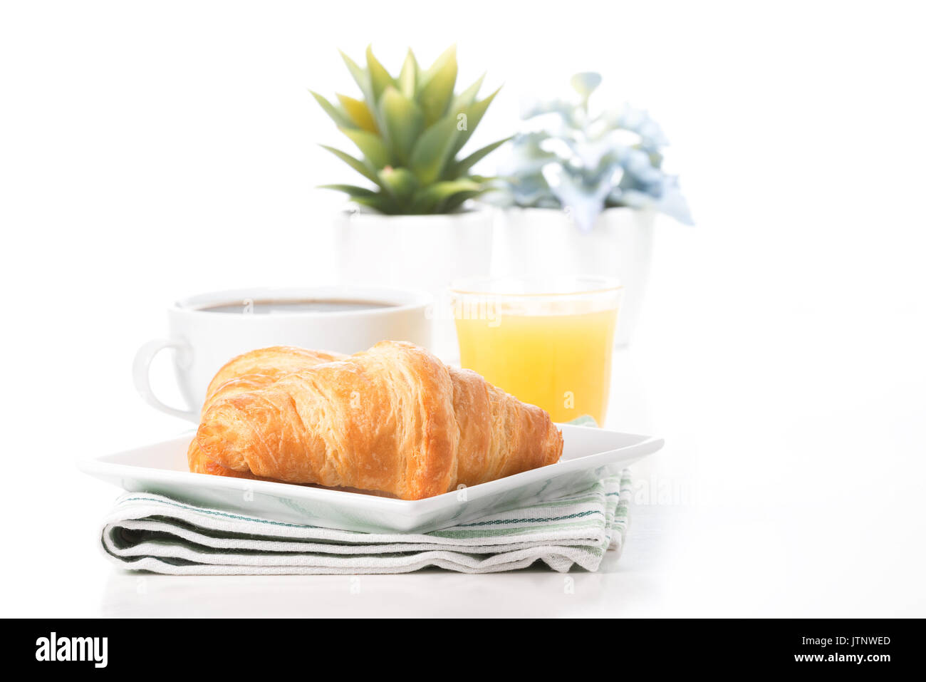 Fresh croissants served with coffee and orange juice. Stock Photo