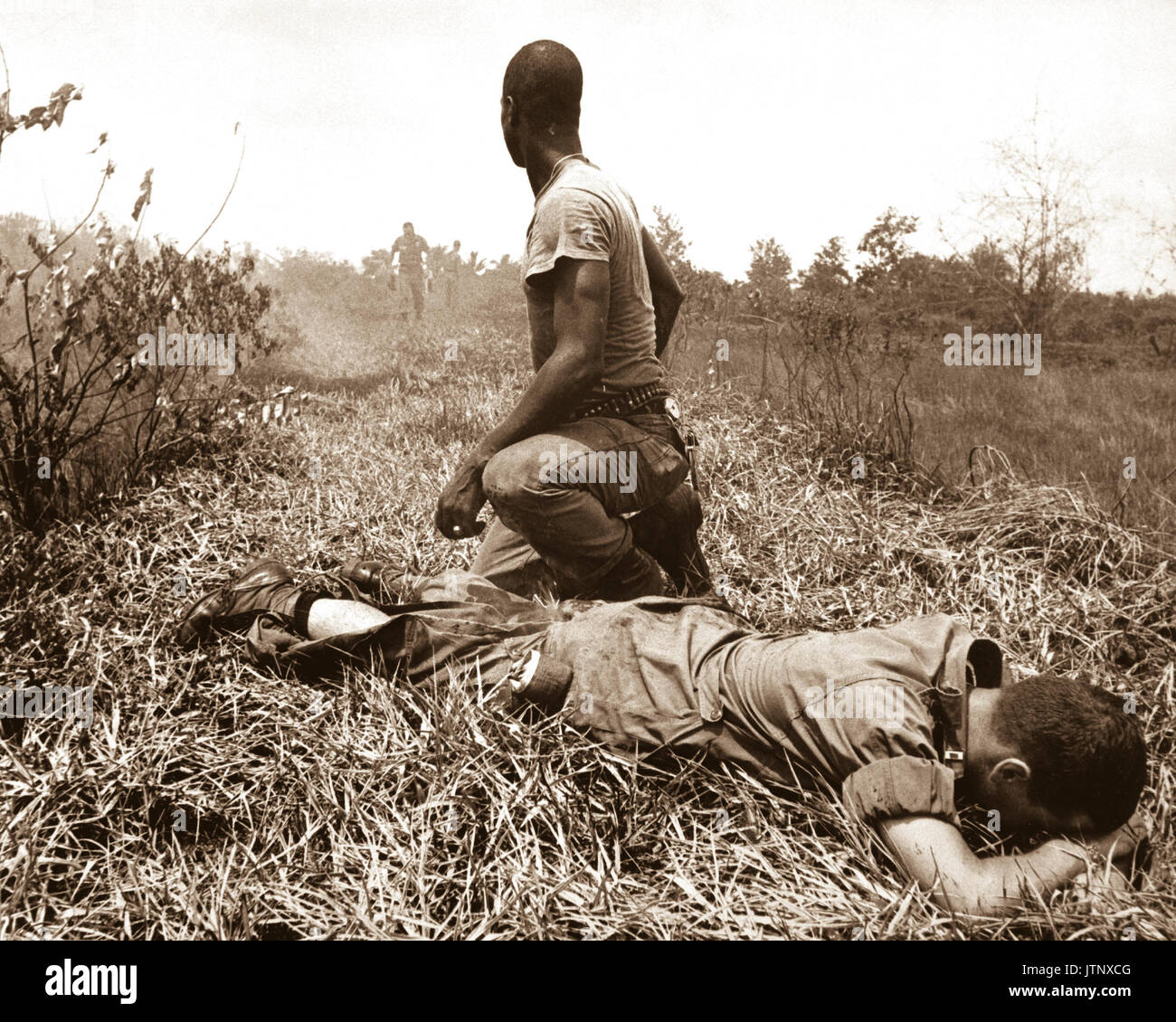 A young American lieutenant, his leg burned by an exploding Viet Cong white phosphorus booby trap, is treated by a medic.  1966.  JUSPAO.  (USIA) EXACT DATE SHOT UNKNOWN NARA FILE #:  306-MVP-16-1 WAR & CONFLICT BOOK #:  404 Stock Photo