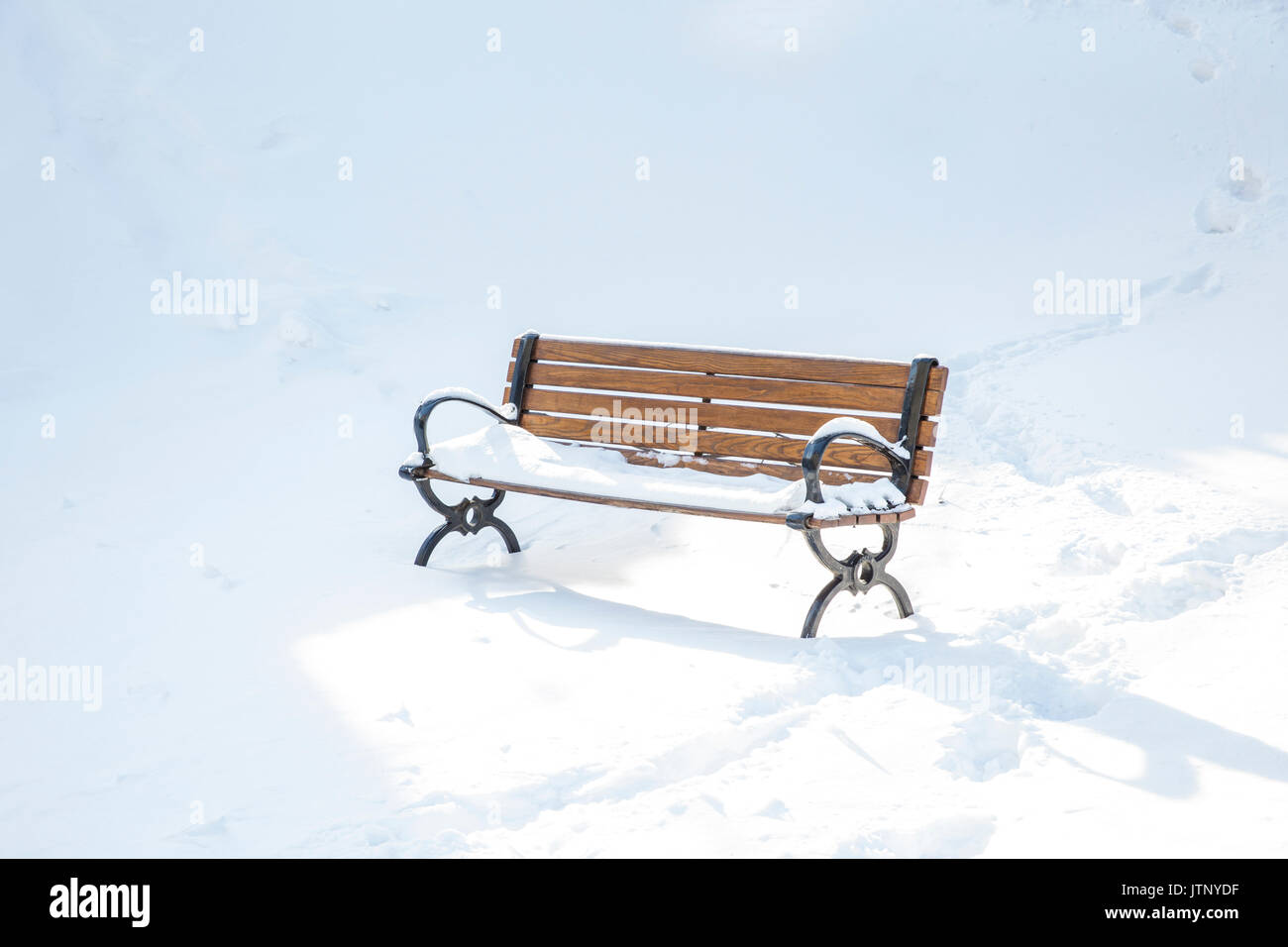 Park bench covered in snow Stock Photo - Alamy