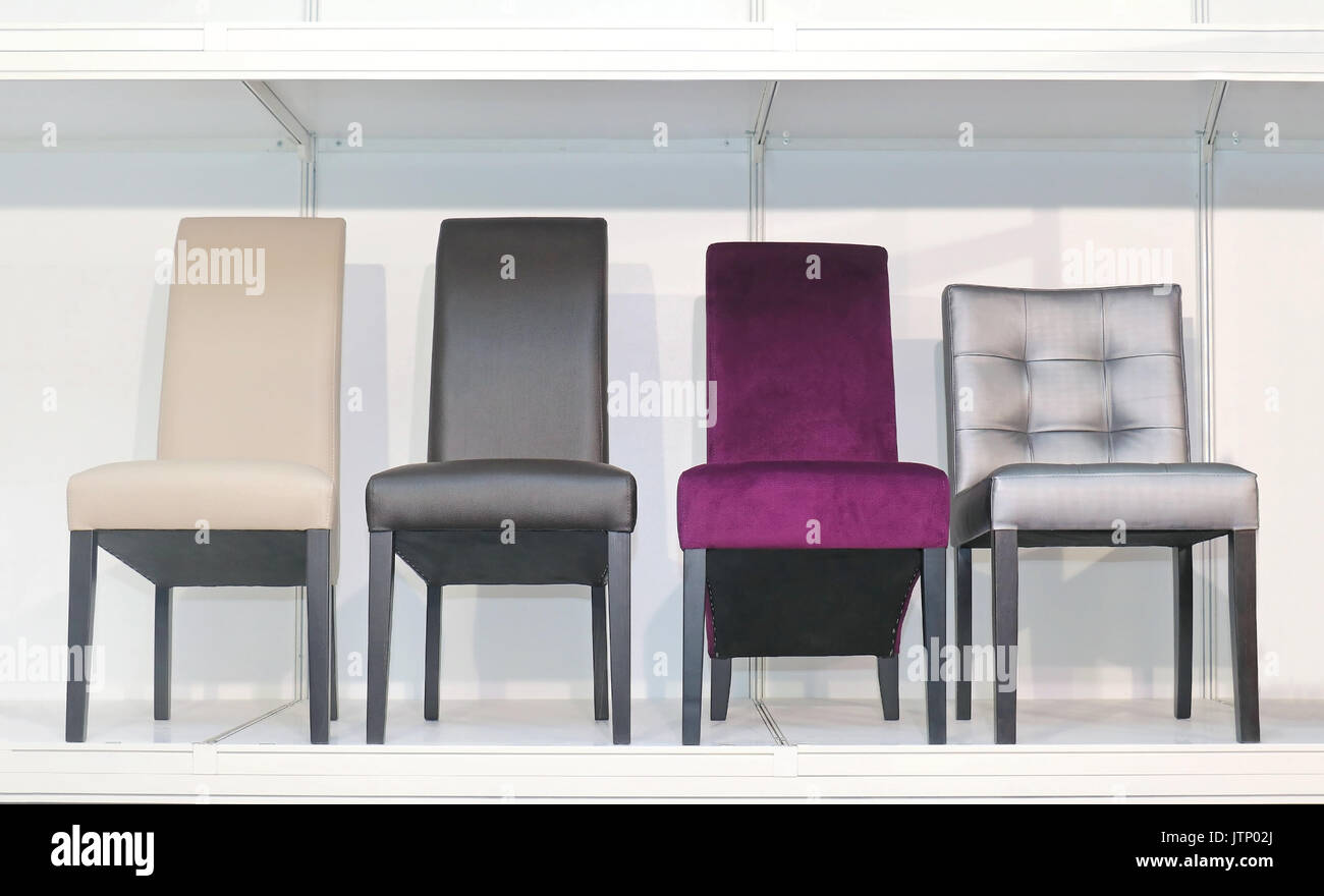 Modern colorful chairs arranged in a row next to each other Stock Photo