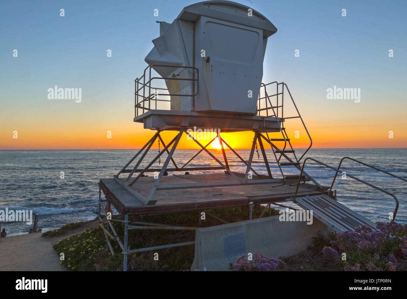 Beach Lifeguard Lookout Tower as Sun Sets behind Pacific Ocean Horizon in La Jolla north of San Diego California USA Stock Photo