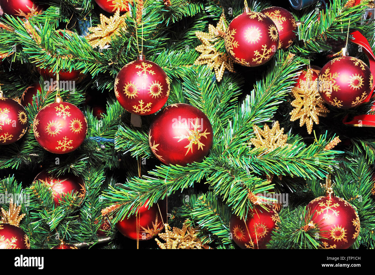 Christmas tree decorated with red balls and gold stars Stock Photo - Alamy