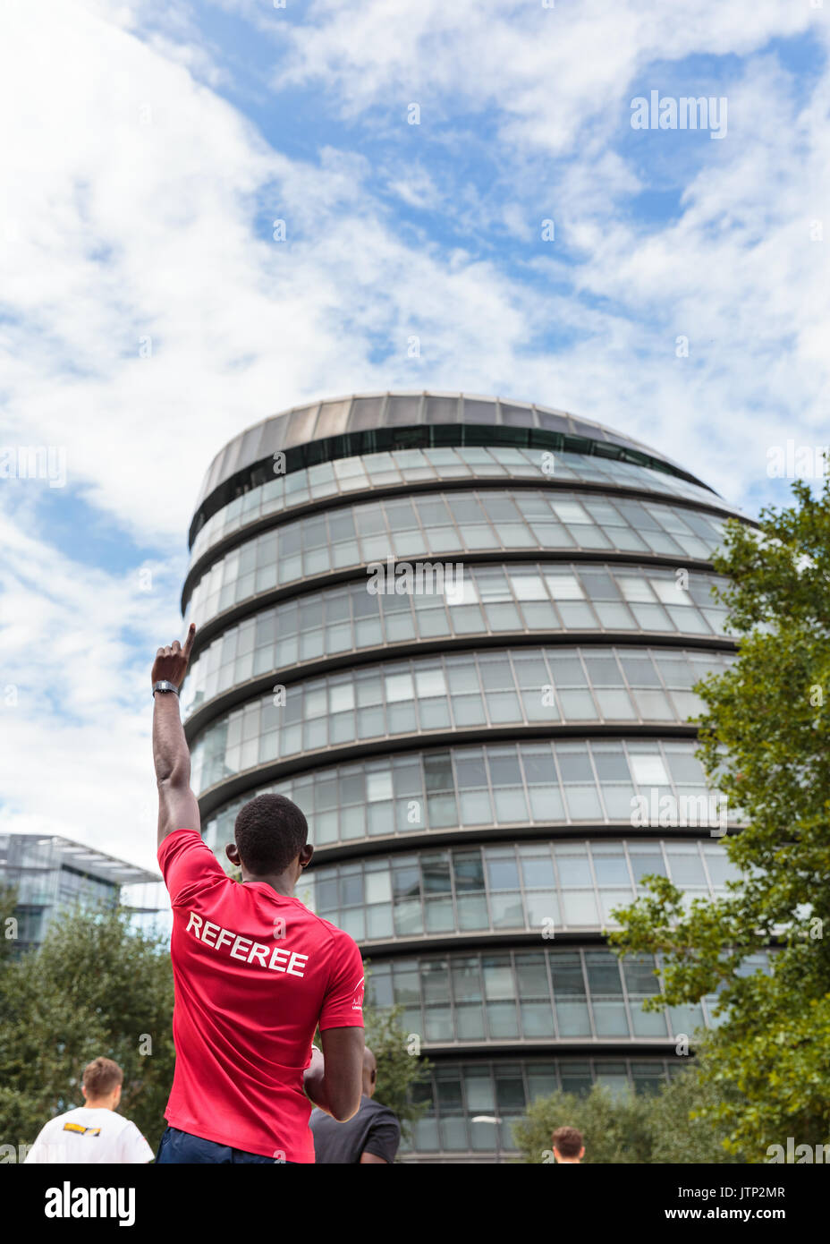 Referee pointing a warning finger on fould play up at City Hall, seat of the local government and Mayor's office, London, UK Stock Photo