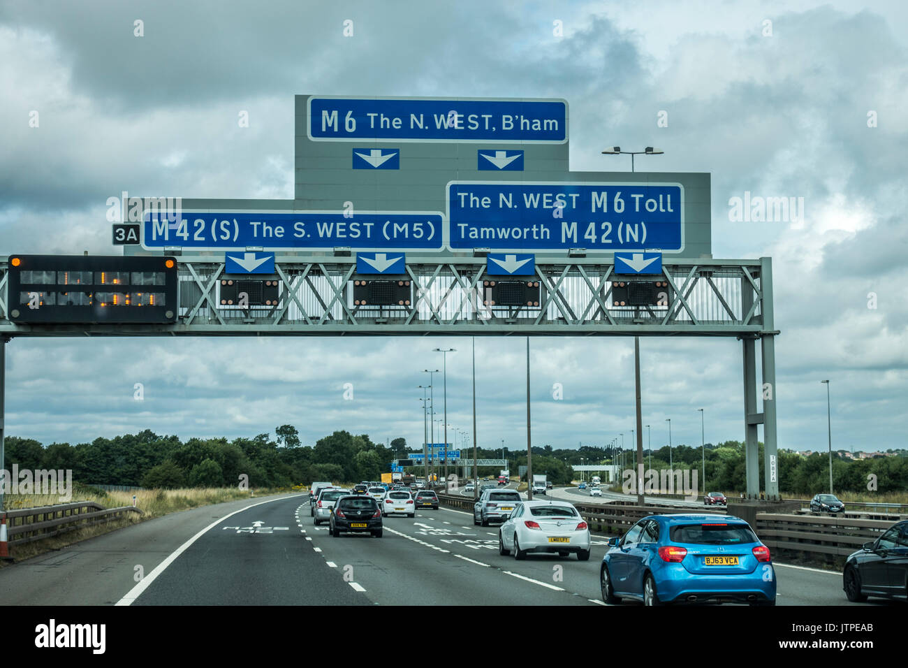 Blue sign on the M6 motorway, east of Birmingham, for the south west or
