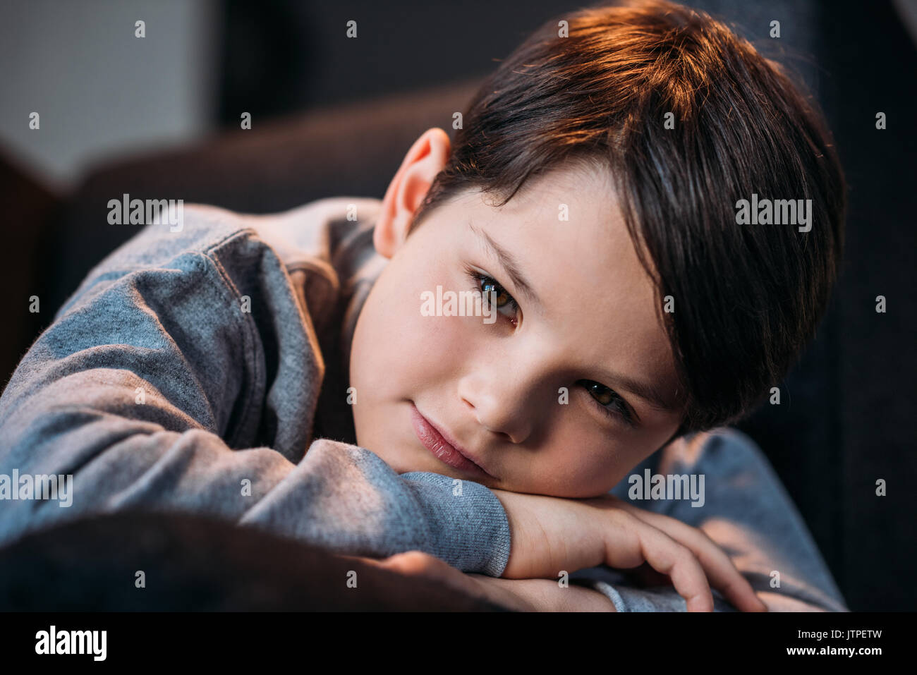 portrait of little cute boy smiling and looking at camera at home Stock Photo