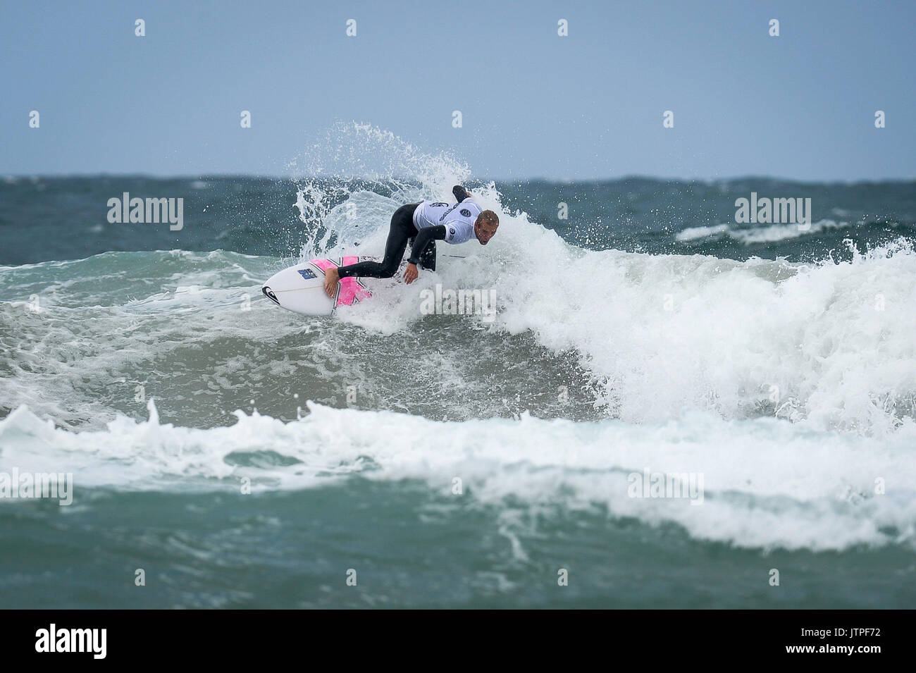 A Surfer Makes A Turn On A Wave During Heats For The World Surf League a-surfer-makes-a-turn-on-a-wave-during-heats-for-the-world-surf-league