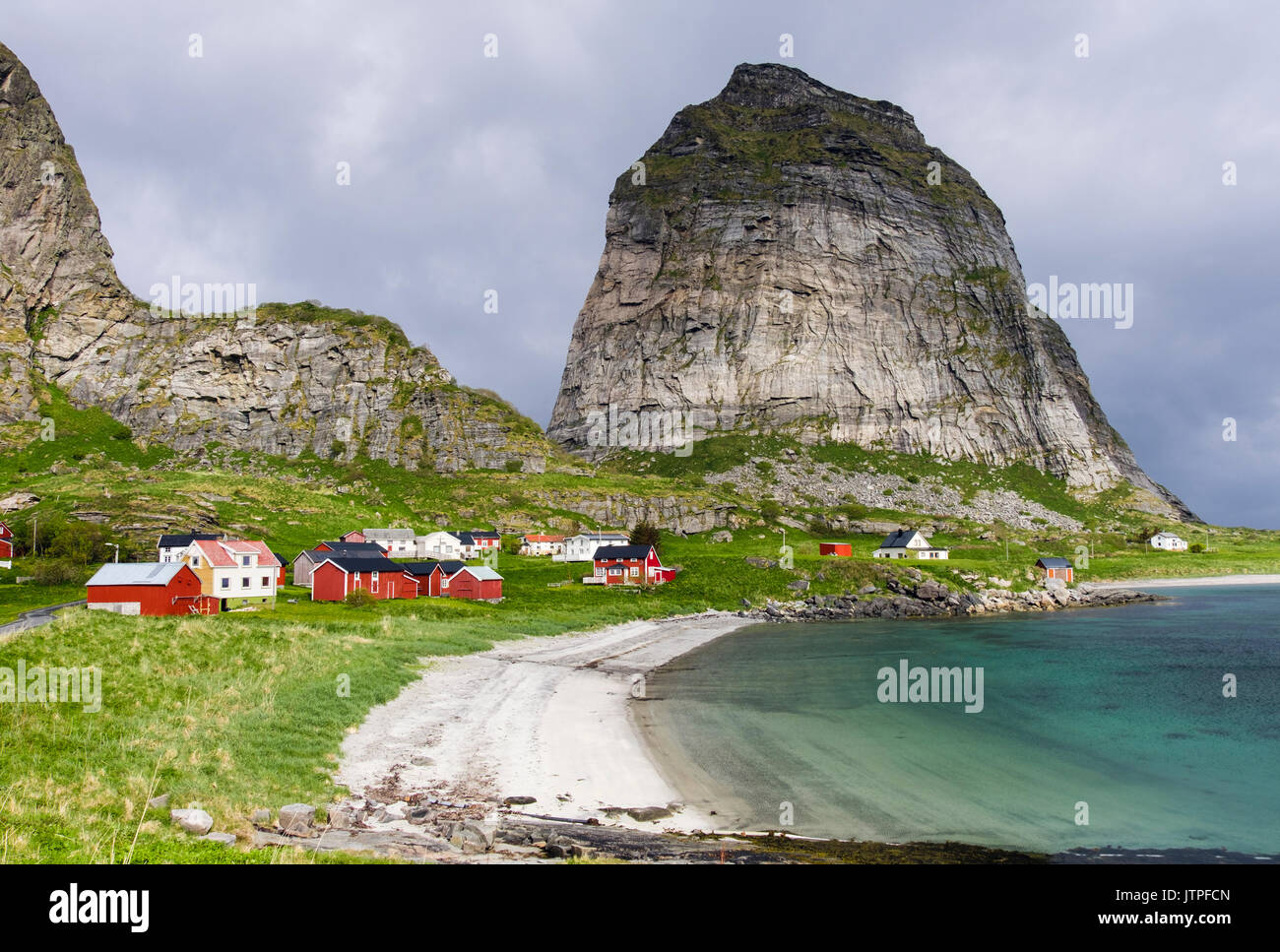 Sanna an old former fishing village houses below Trænstaven mountains in summer on Sanna island, Træna, Nordland county, Norway, Scandinavia Stock Photo