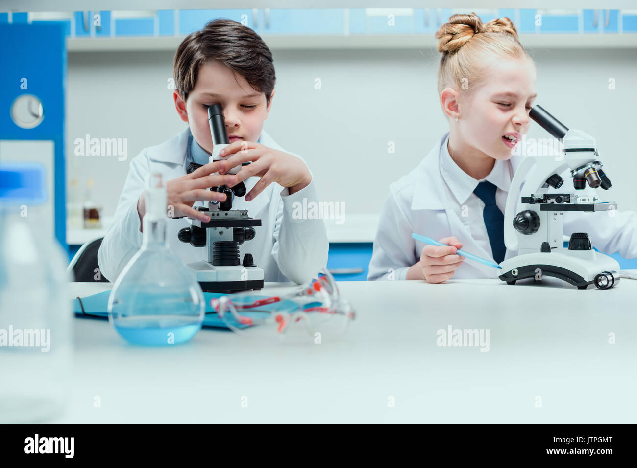 schoolchildren with science lab equipment in chemical lab, scientists kids group concept Stock