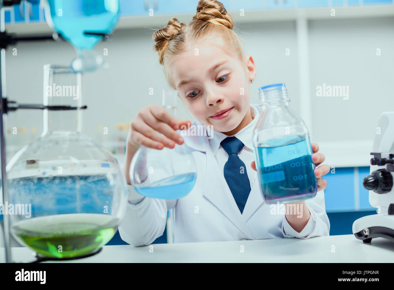Schoolgirl in lab coat hi-res stock photography and images - Alamy
