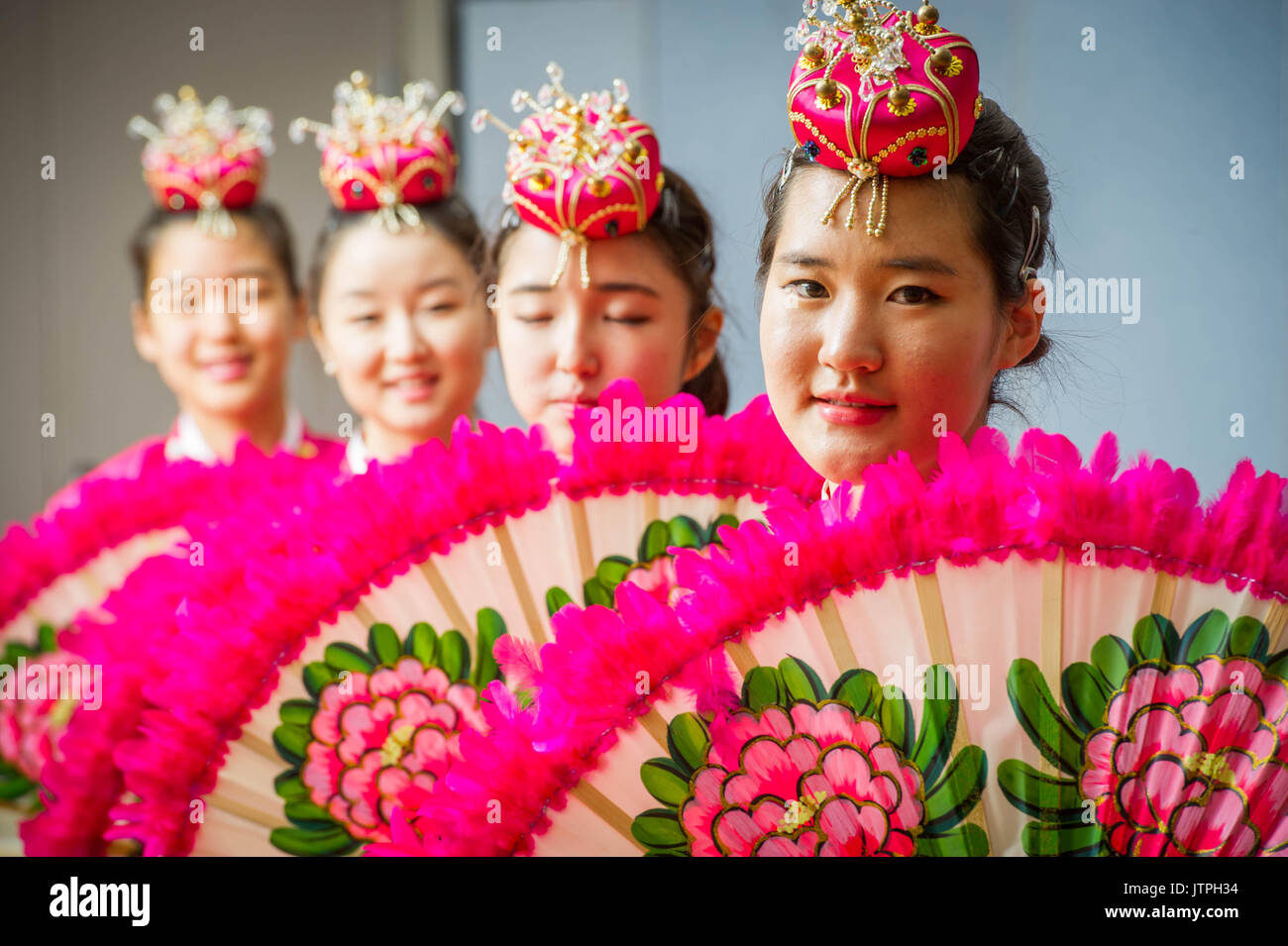Female Korean dancers hold up giant fans during fan dance performance ...