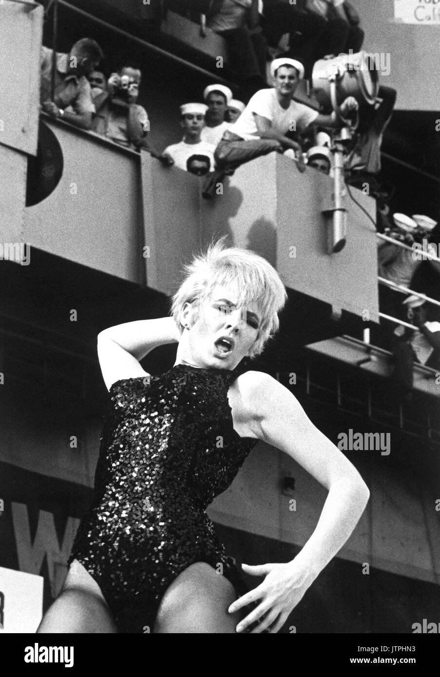Watusi, Frug, Shimmy, Twist!  On a carrier? - It's swinging time on board Ticonderoga as Miss Joey Heatherton rocks out with a 'Tico Tiger' during the Bob Hope Show.  (USIA) NARA FILE #:  306-MVP-8-6 WAR & CONFLICT BOOK #:  391 Stock Photo