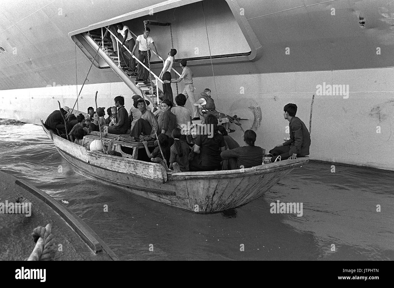 Vietnamese refugees prepare to come aboard the USS BLUE RIDGE (LCC-19).  The refugees were rescued by the amphibious command ship 350 miles northeast of Cam Ranh Bay, Vietnam, after eight days at sea in a 35 foot fishing boat. Stock Photo