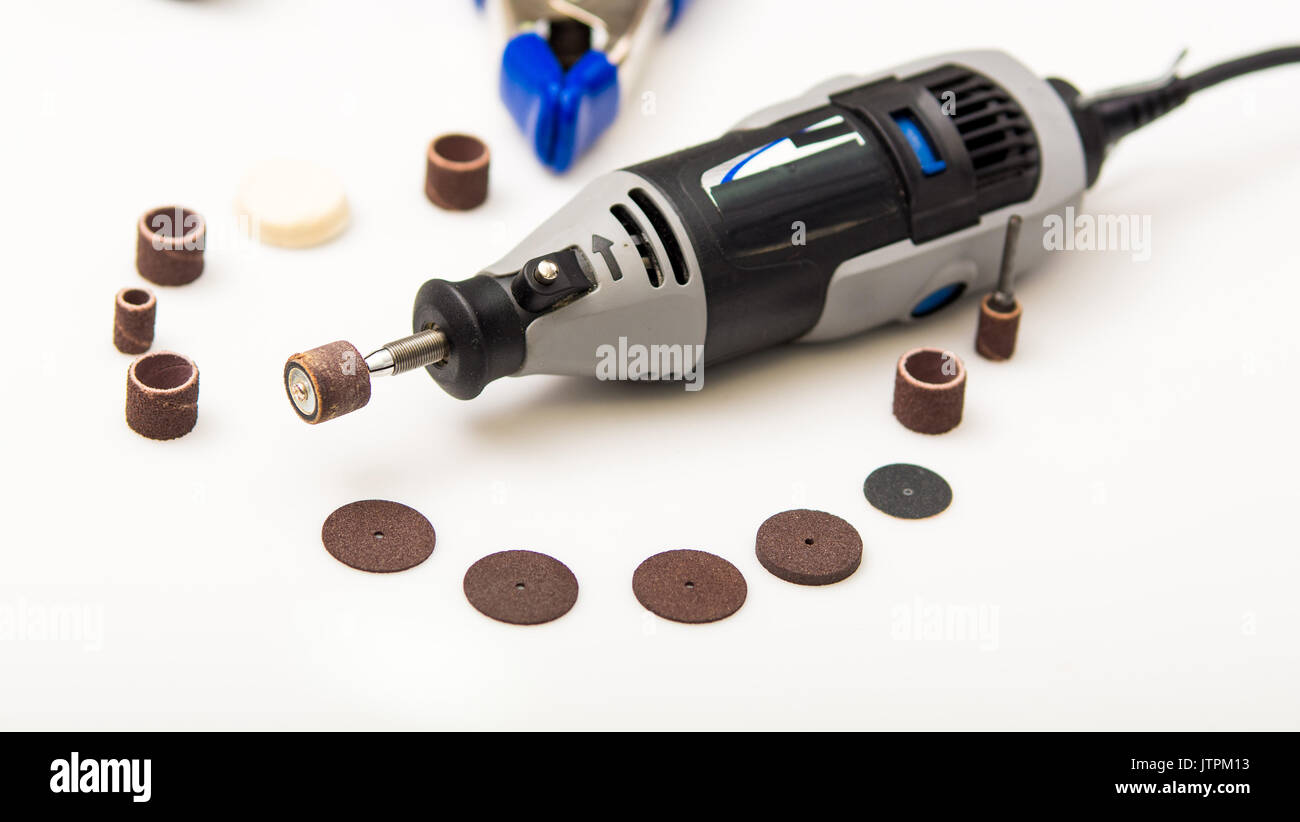 A gray drill with drilling accessories on white background Stock Photo