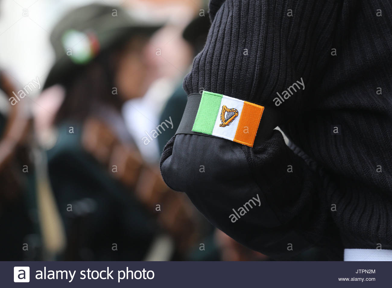 The Irish tricolour with a harp in the middle on the sleeve of a participant at a political demonstration in O'Connell Street, Dublin. Stock Photo