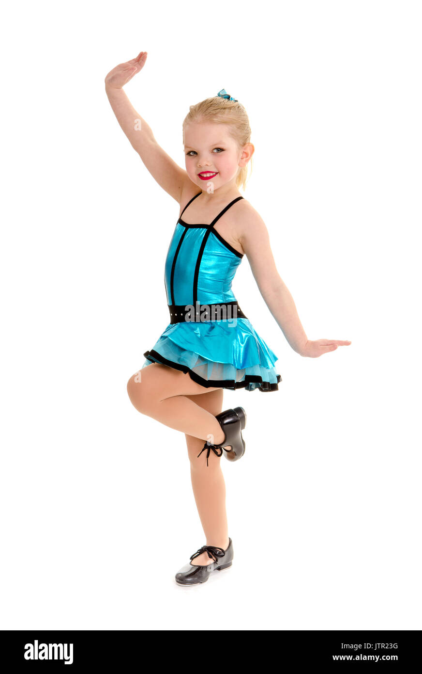 Cute Little Girl Tap Dancer Poses with Leg  Lifted in Tap Shoes and Costume Stock Photo