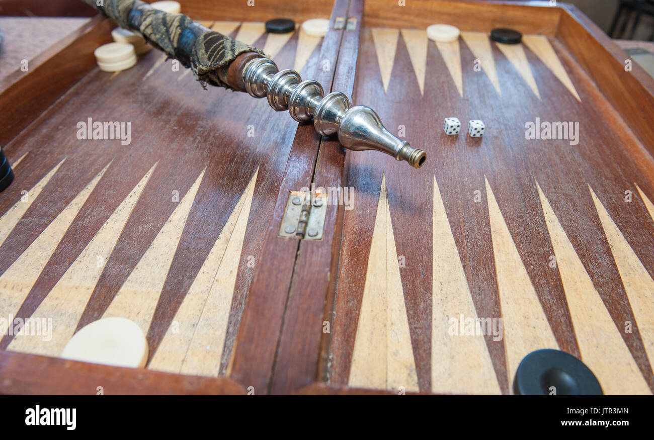Closeup of backgammon board game and shisha water pipe in traditional egyptian street cafe coffee shop Stock Photo