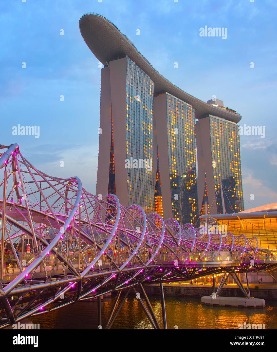 SINGAPORE - JAN 13, 2017: Helix bridge and Marina Bay Sands Resort at twilight in Singapore. Marina Bay as the world's most expensive standalone casin Stock Photo