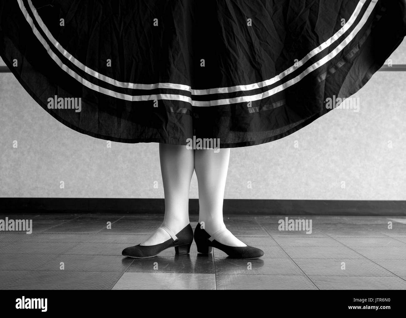 Black and white version of Character Ballet dancer in first position holding her skirt Stock Photo