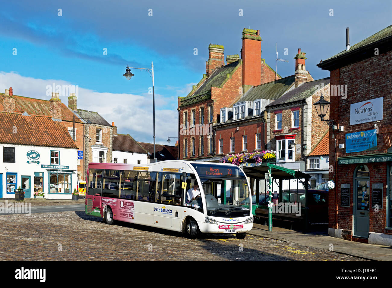 Bus in the market place, Thirsk, North Yorkshire, England UK Stock Photo