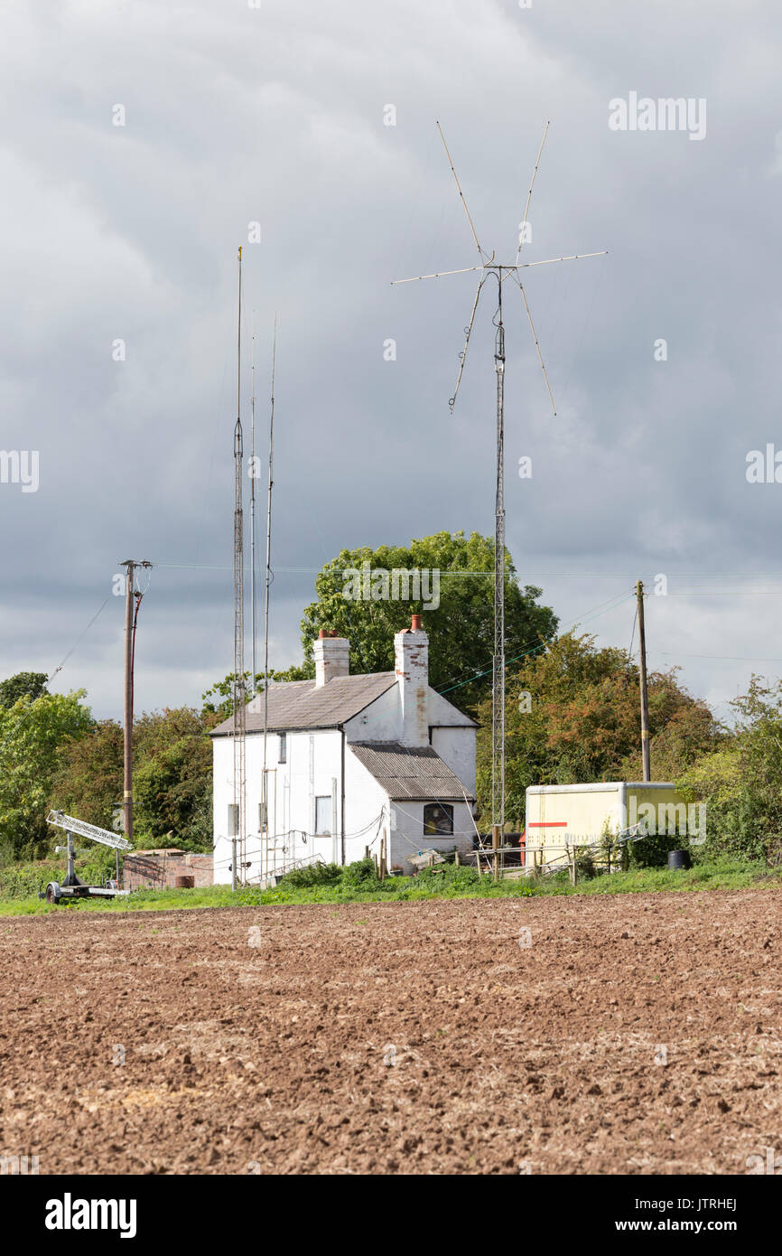 Amateur radio masts on a country cottage, England, UK Stock Photo