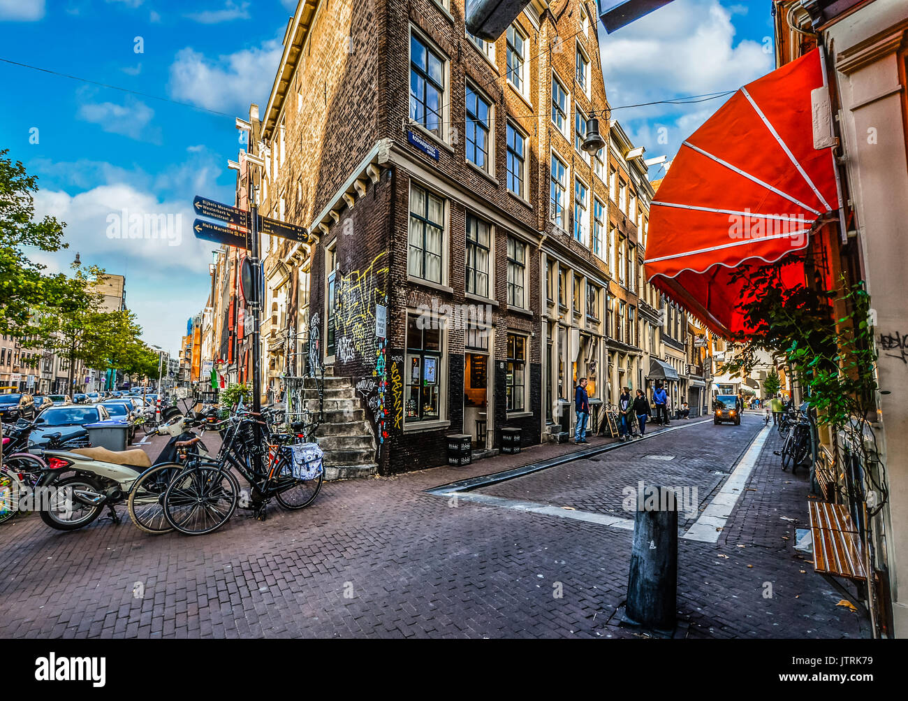 A corner cafe with colorful graffiti in the tourist section of Amsterdam Stock Photo