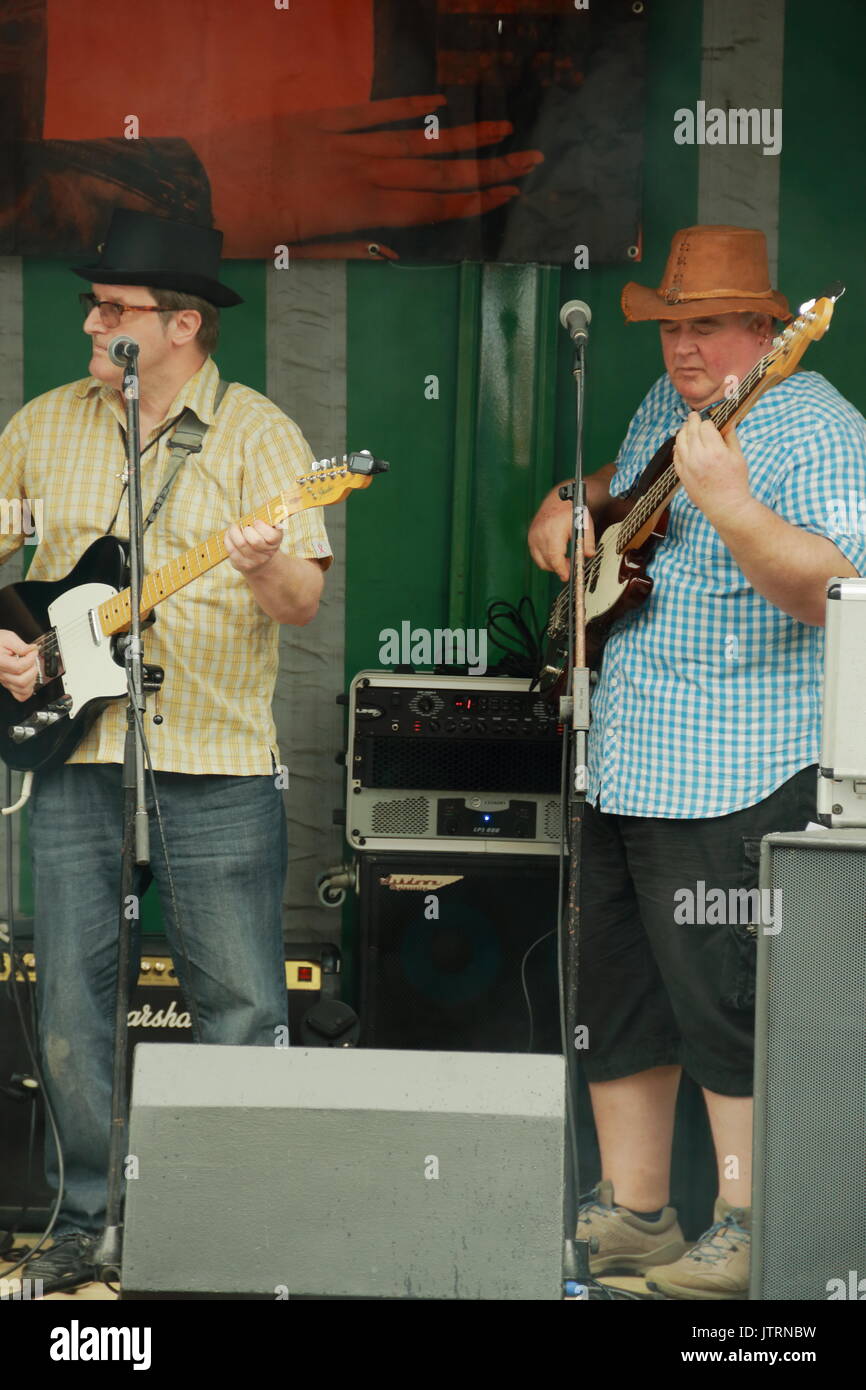 Five little pigs guitar and bass players,quayside music festival,weymouth,dorset,uk Stock Photo