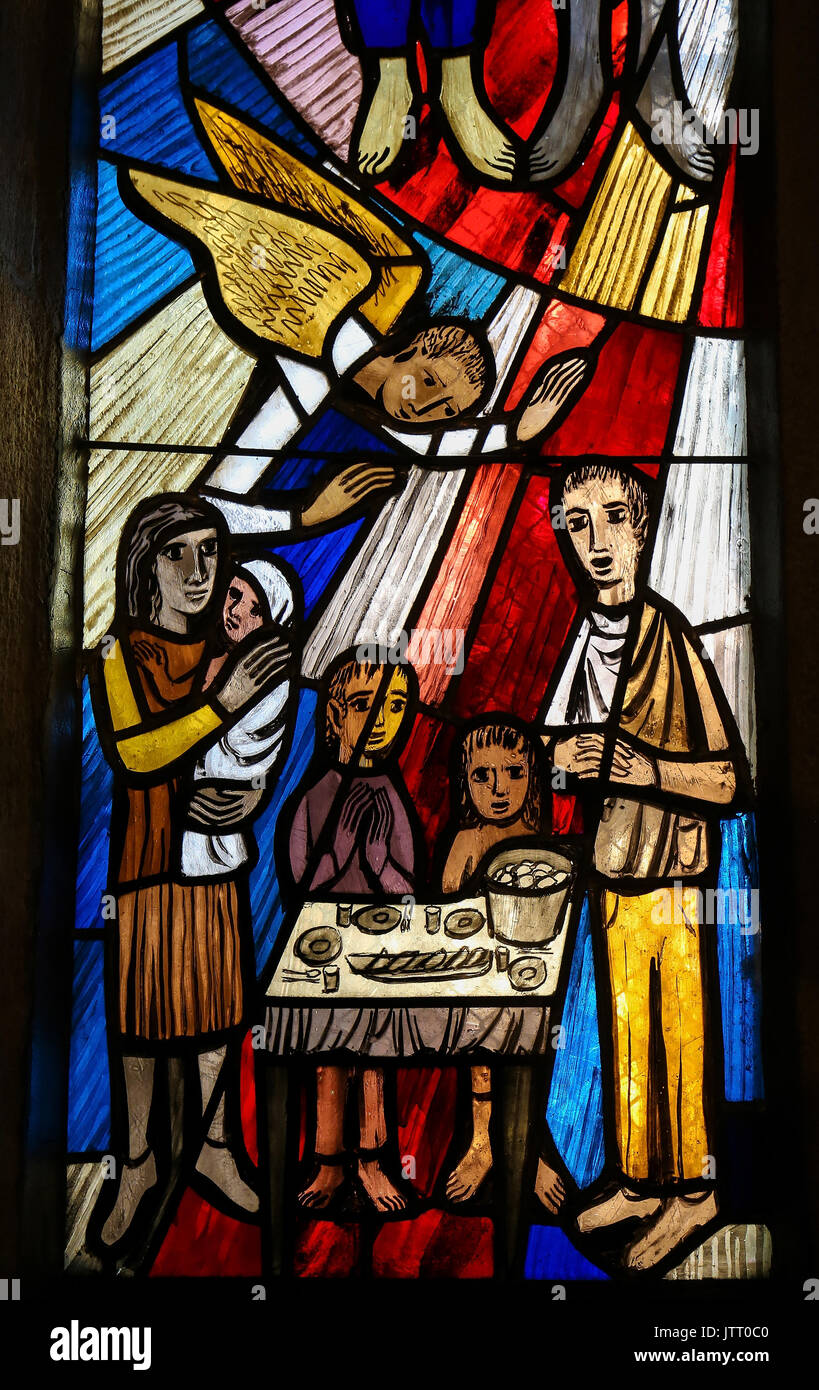 Stained Glass in the Stiftskirche Church in Tubingen, Baden-Wurttemberg, Germany, depicting a family gathered around a table, praying Stock Photo